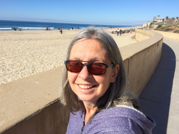 Janet walked that pathway from those rocks behind her. Nice place to exercise. Carlsbad Beach.